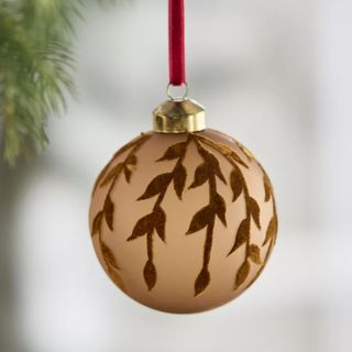 gold round christmas tree ornament with leaf pattern