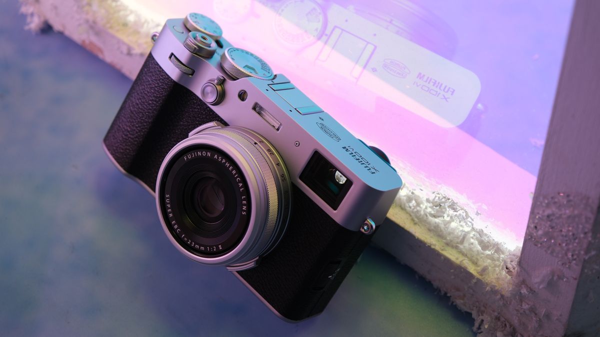 Fujifilm X100VI camera in front of a purple neon light