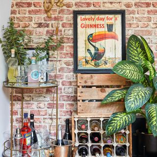 exposed brick wall behind drinks counter with plants and framed art