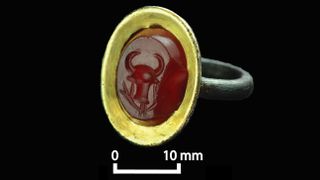 This gold ring from the basilica is inlaid in the semiprecious stone cornelian. Although the ring is in an ancient Roman style, the engraved design of the head of a bull and vines is Aksumite.