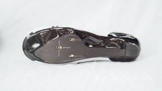 The carbon undersole of a white road cycling shoe