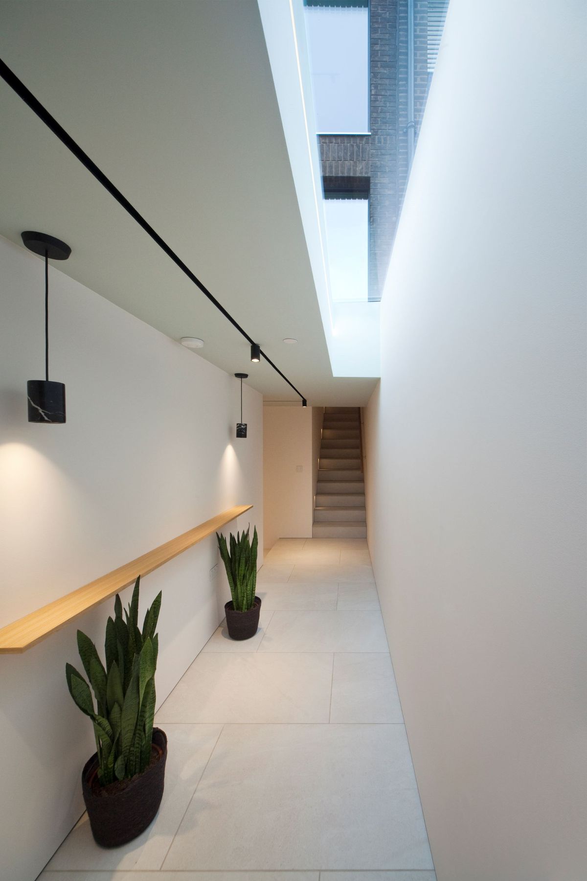 The hallway in the triangle shaped home showing a window in the ceiling