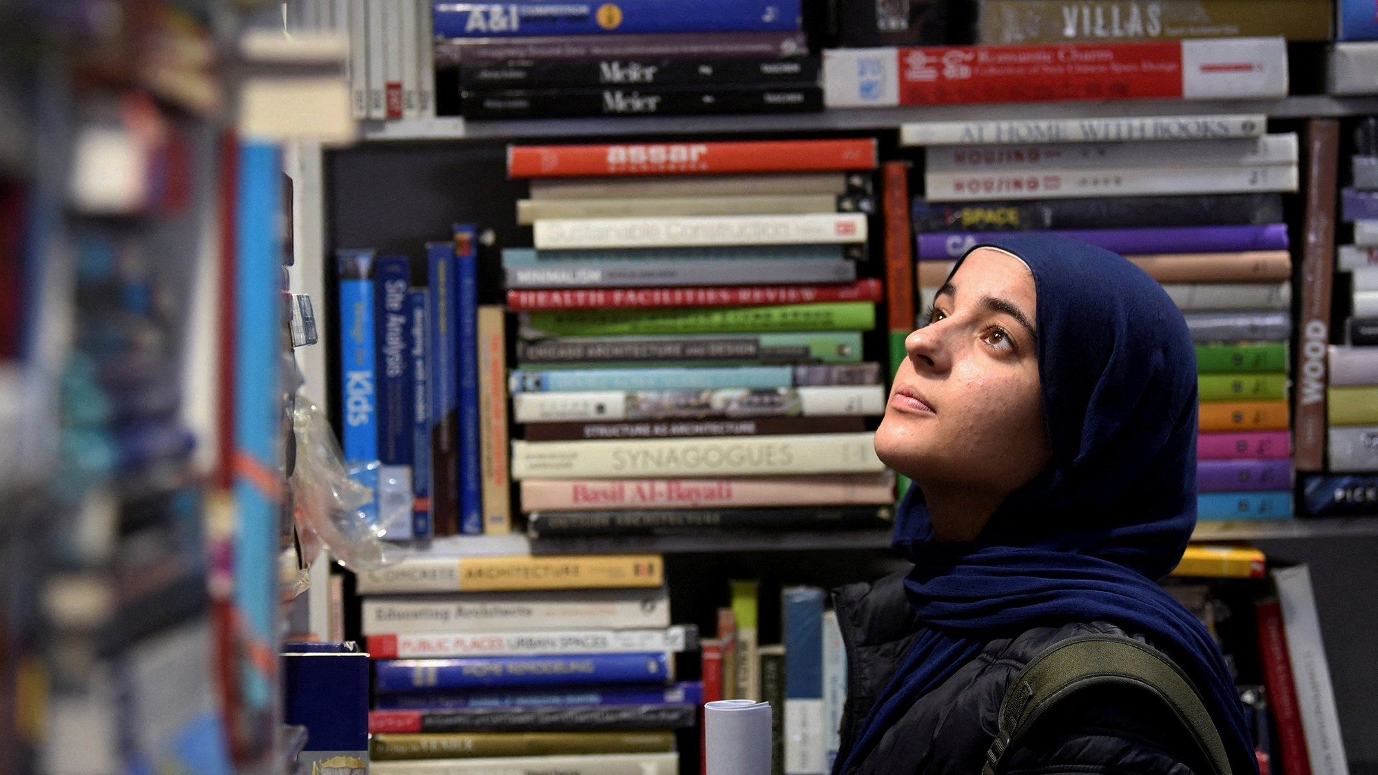 A woman shops for books during the 57th Cairo International Book Fair in Cairo, Egypt