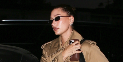 Hailey Bieber enjoyed a coffee-tasting session at Pacific Café in West Hollywood. She looked effortlessly stylish in a long tan trench coat with a classic belted waist, paired with navy loafers and retro sunglasses.