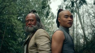 Iroh and Zuko stand back-to-back in a forest in Netflix's Avatar: The Last Airbender TV show