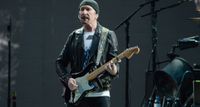 The Edge plays his 1973 Black Strat onstage
