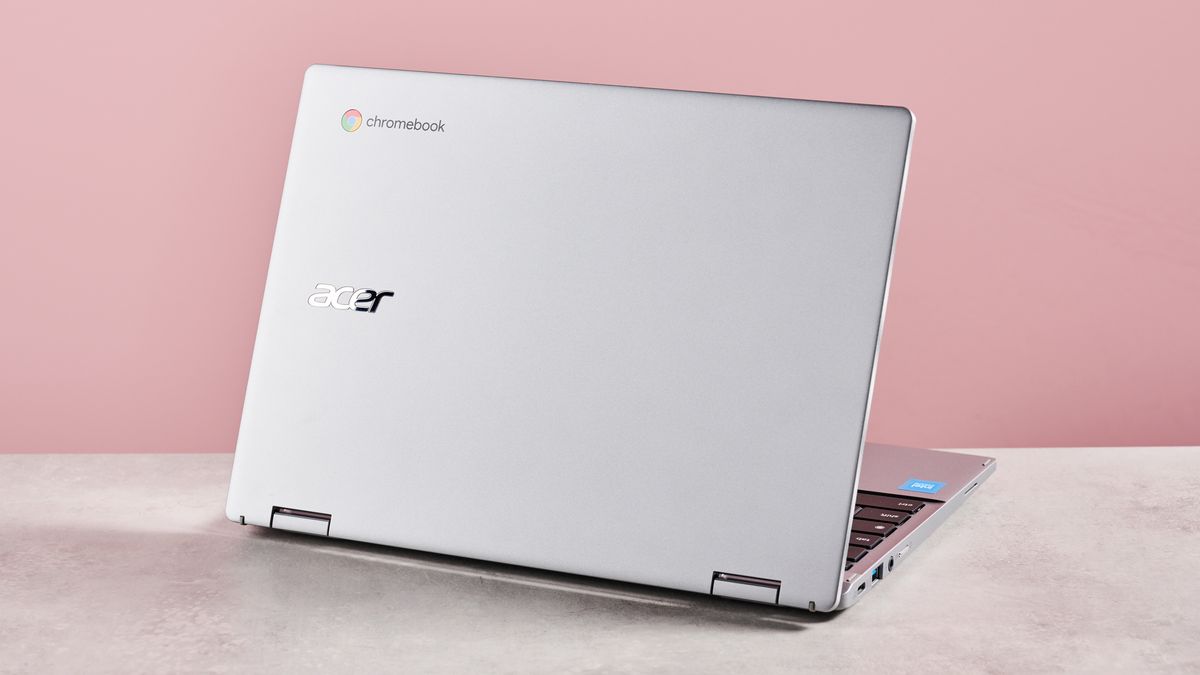 Back of Acer Chromebook Spin 312 open on desk with pink background