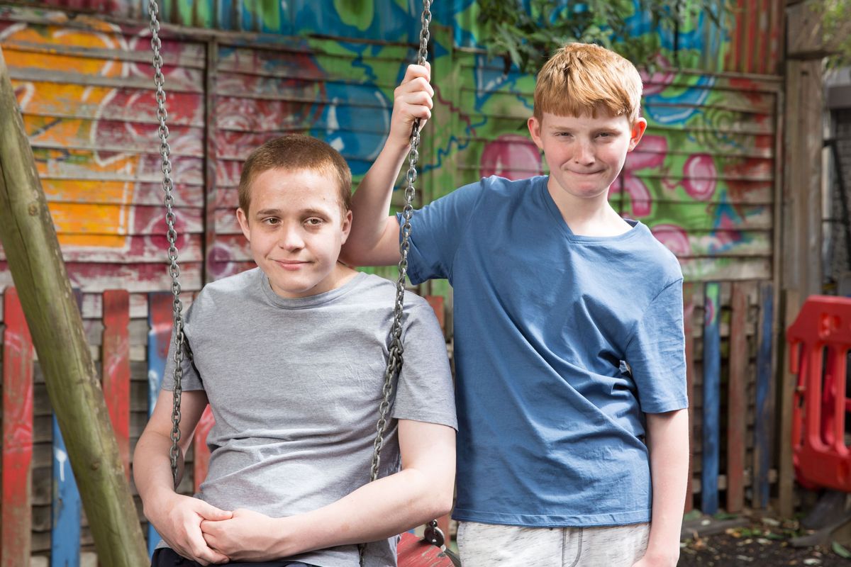 Riley and Chatham Taylor pose on the swing.