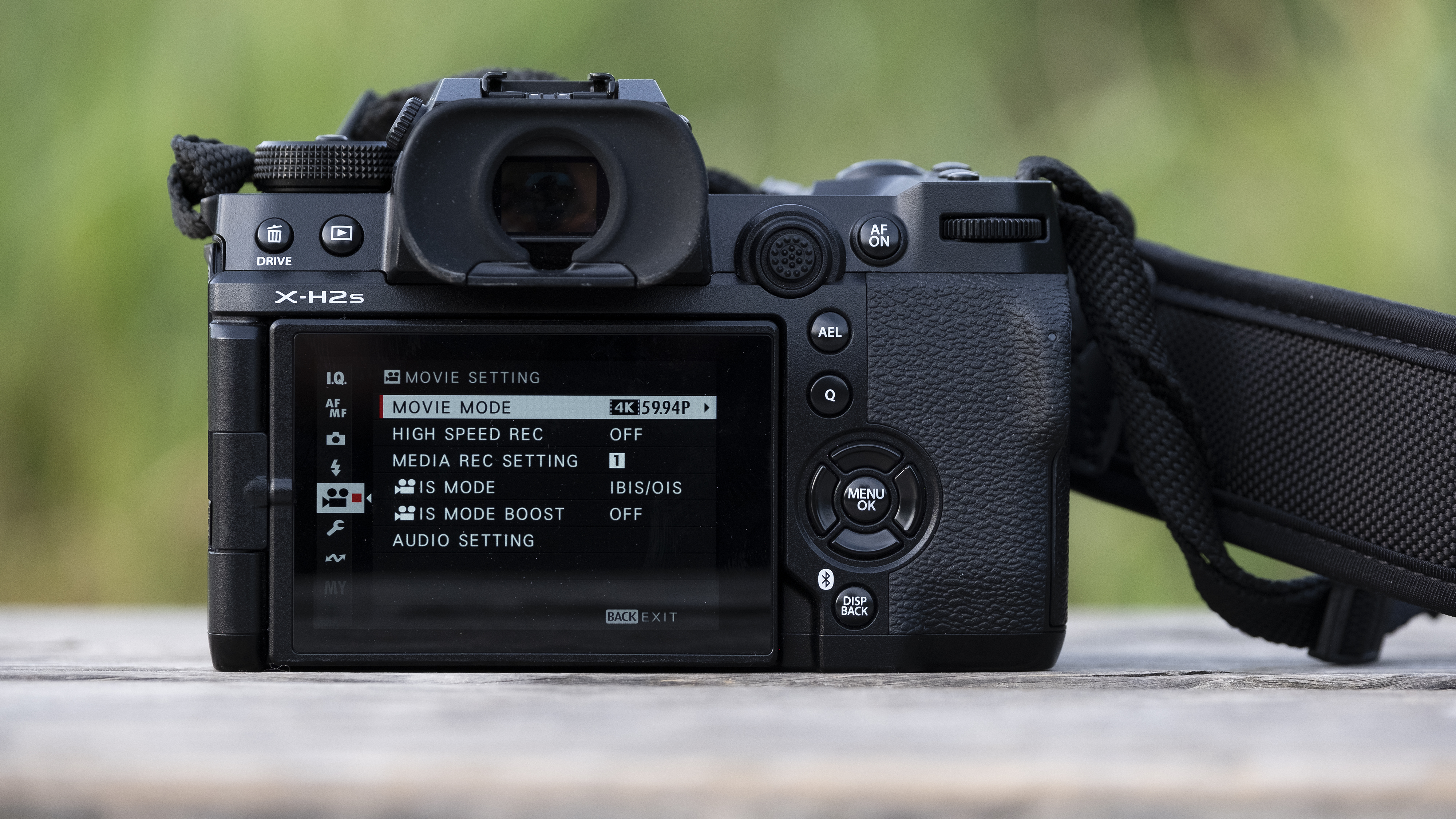 The Fujifilm X-H2S camera sitting on a wooden bench