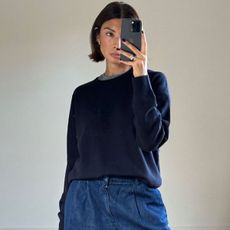 woman in navy sweater and jeans