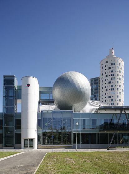 Large wood and metal building with solar panels on the roof