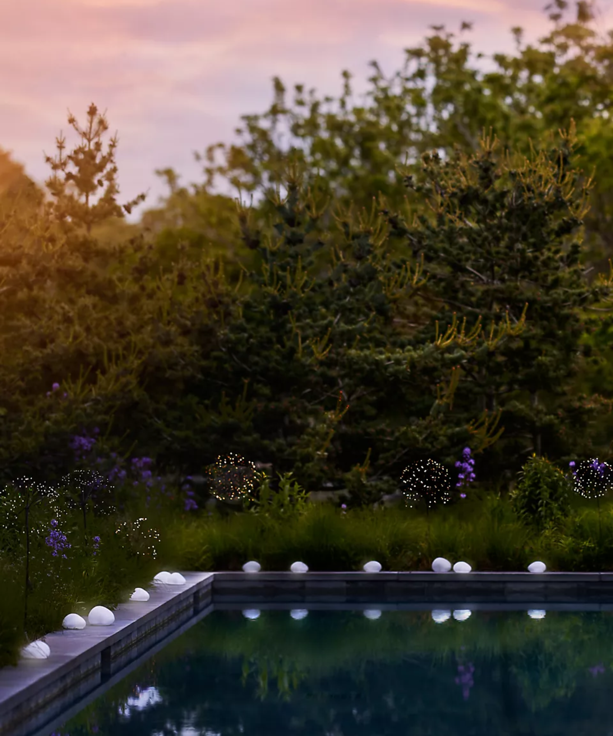 a pool with solar pebble lights around it