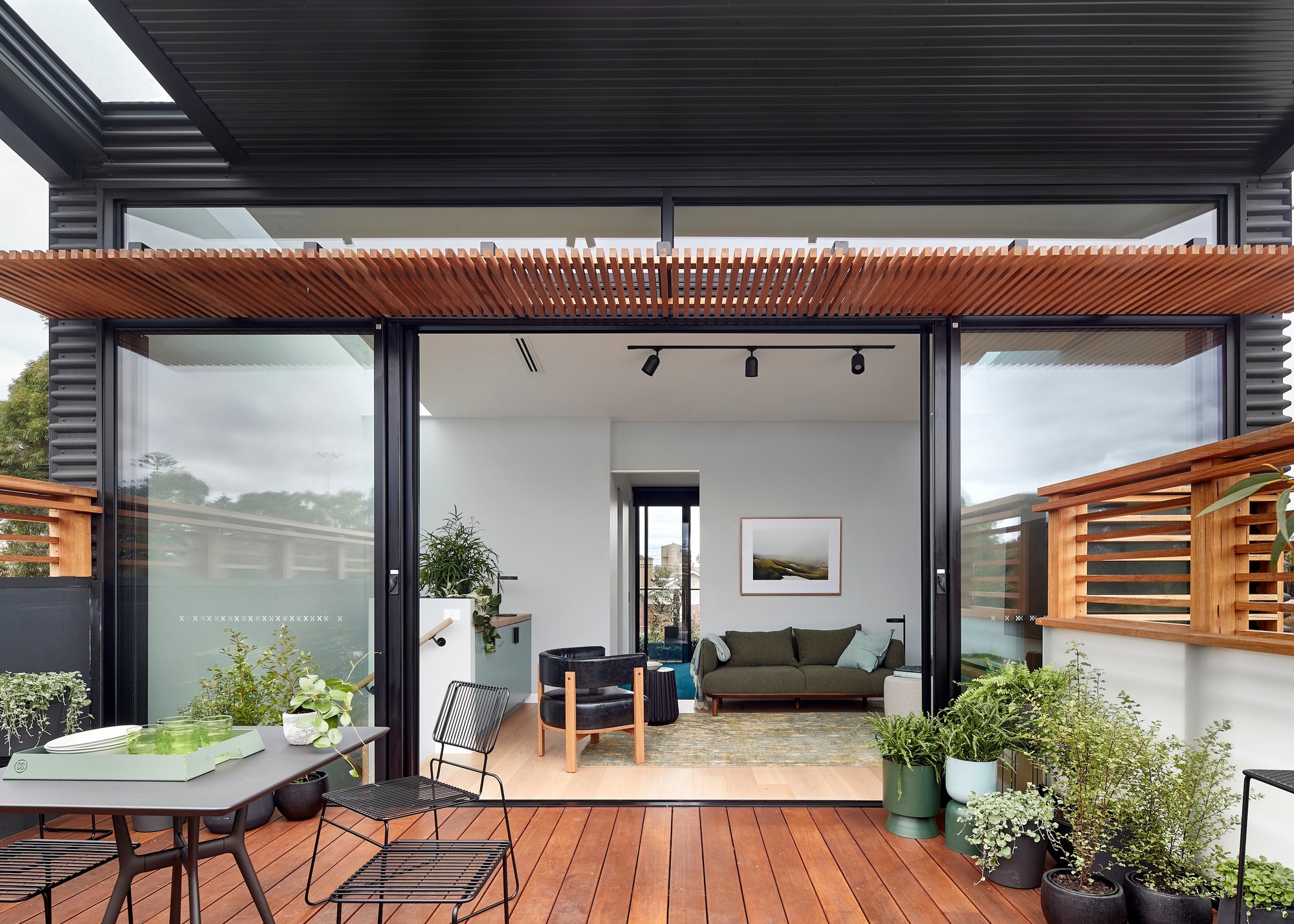 a balcony with a timber sunscreen and timber deck