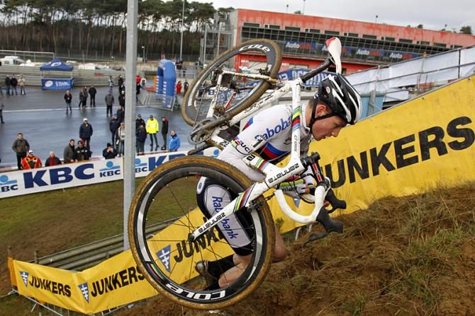 World champion and World Cup leader Mathieu van der Poel shoulders his bike at the Zolder World Cup round.