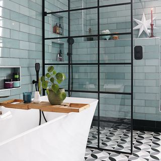 bathroom with walk in shower and green tiles