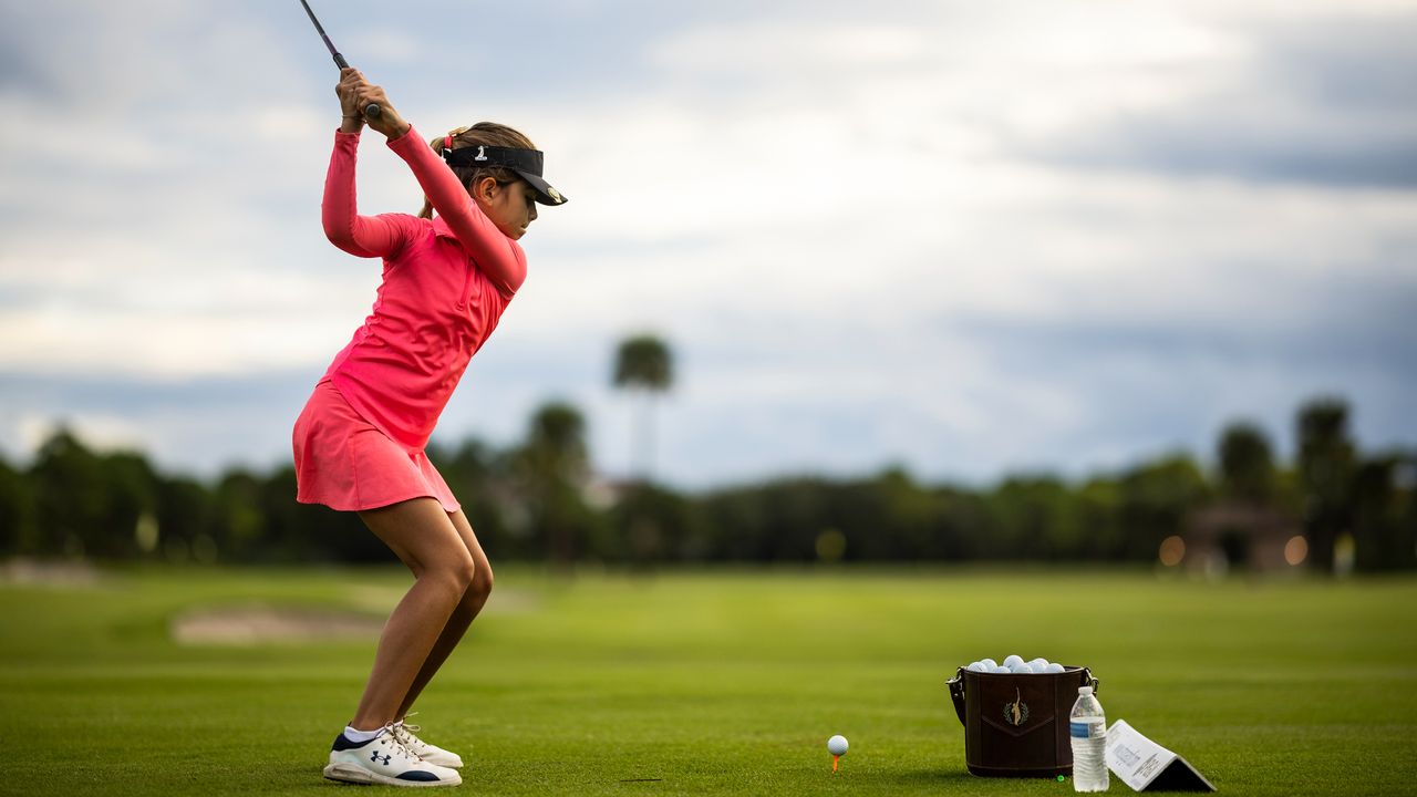 Bella Simoes warms up on the driving range during the 2022 Drive, Chip and Putt Championship Regional Qualifier