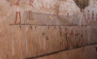 In this tomb scene, men can be seen herding or corralling cattle and people are carrying a variety of goods.