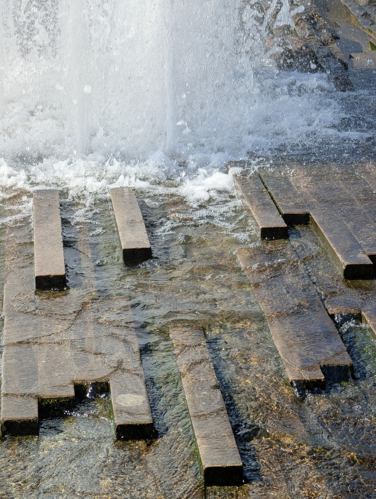 Fountain water splashing over concrete
