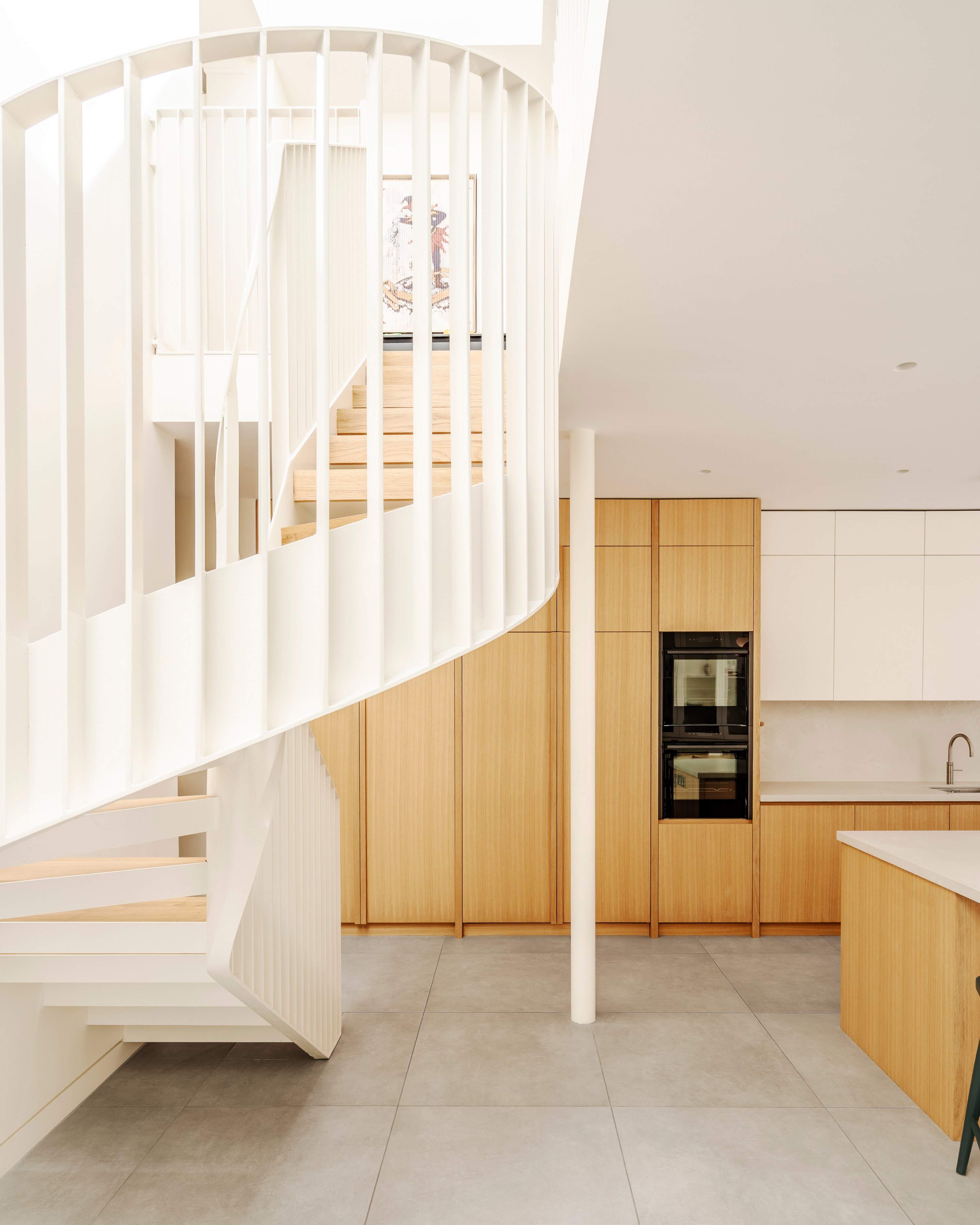 A bespoke metal staircase leads from kitchen to sitting room