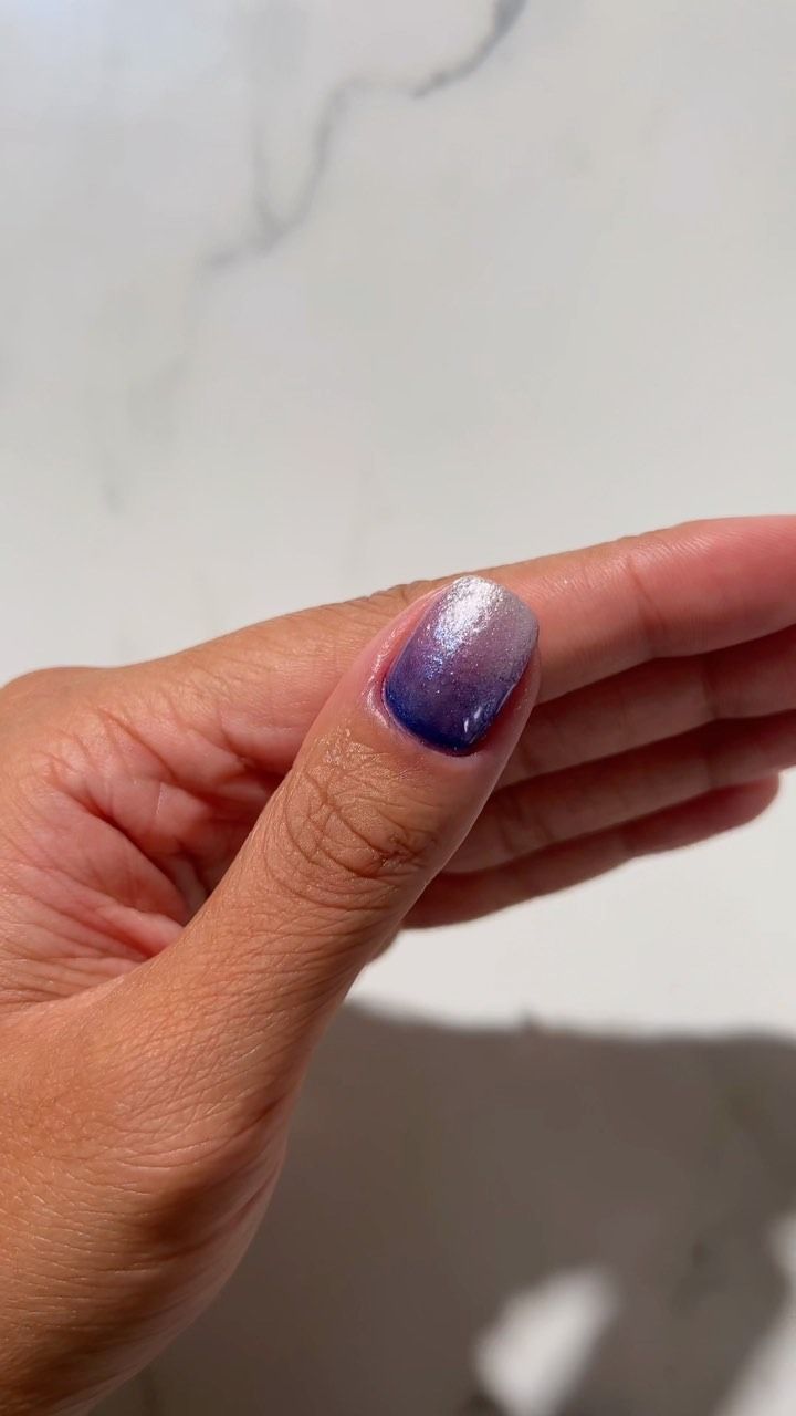 A purple ombre glitter manicure