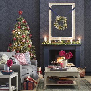 living room with christmas tree and candles with wallpaper on wall