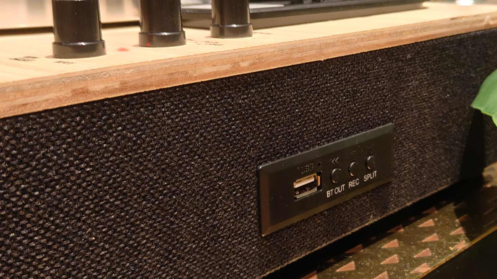 The Majority Folio on a bronze table with plants in the background.