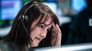 Dispatcher Katie has a headache as one quarter of the ambulance crews are at hospitals waiting to admit patients in "Ambulance" season 15