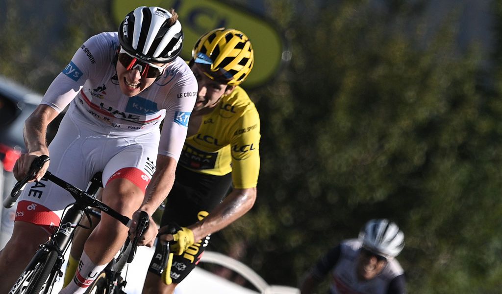 Stage winner Team UAE Emirates rider Slovenias Tadej Pogacar L wearing the best youngs white jersey celebrates as he crosses the finish line ahead of Team Jumbo rider Slovenias Primoz Roglic wearing the overall leaders yellow jersey at the Grand Colombier pass during the 15th stage of the 107th edition of the Tour de France cycling race 175 km between Lyon and Grand Colombier on September 13 2020 Photo by AnneChristine POUJOULAT AFP Photo by ANNECHRISTINE POUJOULATAFP via Getty Images