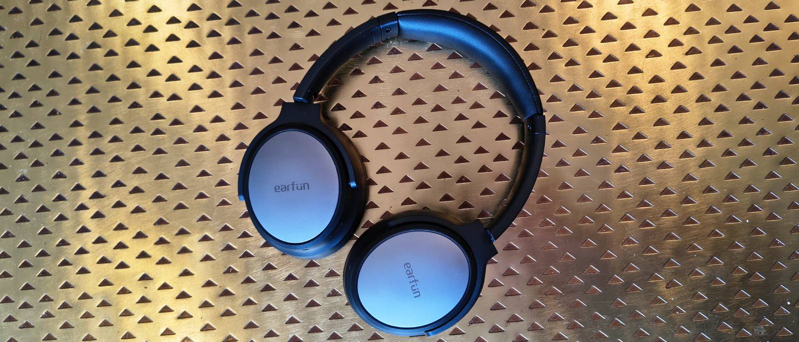 The Earfun Tune Pro atop a bronze table.