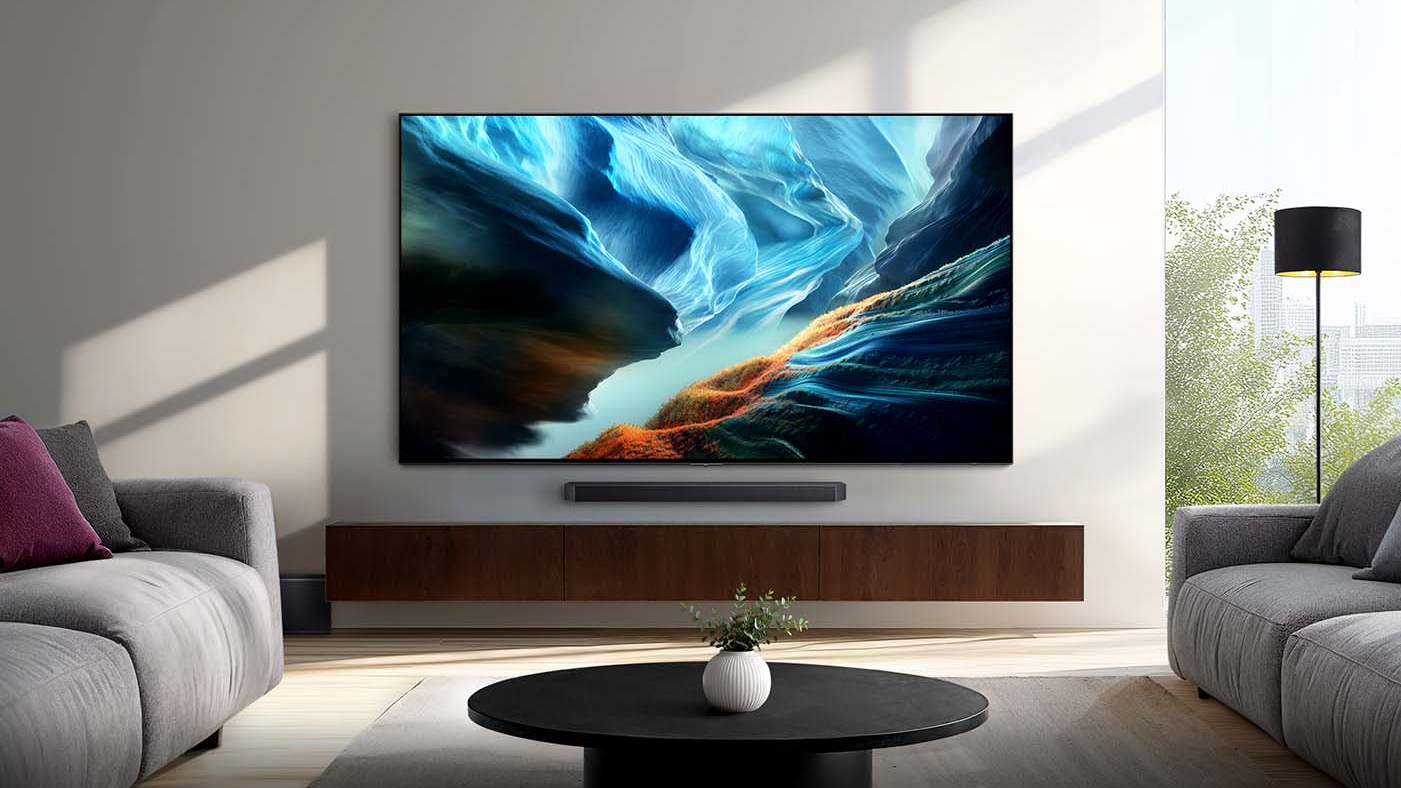 The wall-mounted Samsung S90H OLED TV displaying colorful, abstract imagery in a well-lit, contemporary living room