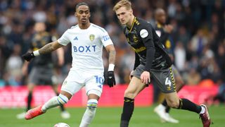Crysencio Summerville of Leeds United takes on Southampton's Flynn Downes in a May 2024 EPL encounter.