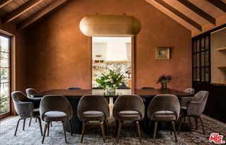 a dining room with copper lime wash walls