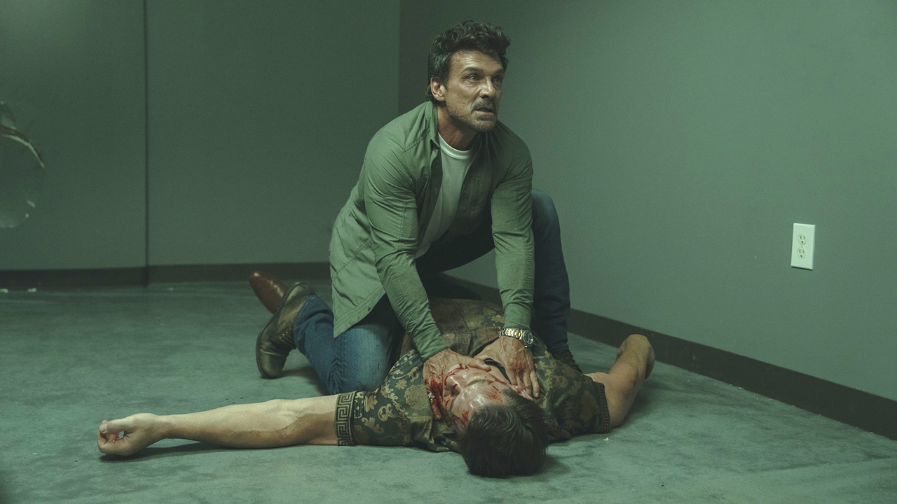 Rick Flag Sr looking up as he strangles a prone Chris Smith in Peacemaker season 2 episode 5