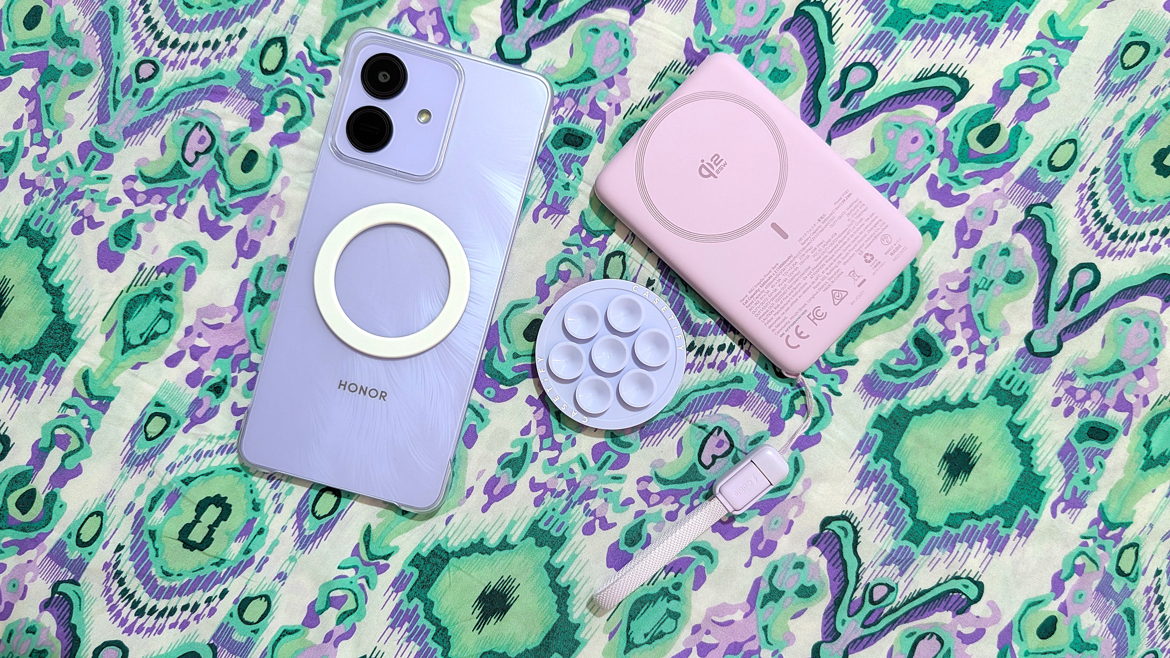 Honor Play 10 with a clear case, a magnetic ring sticker, and MagSafe accessories.