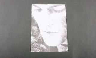 Black and white print of a model's face.