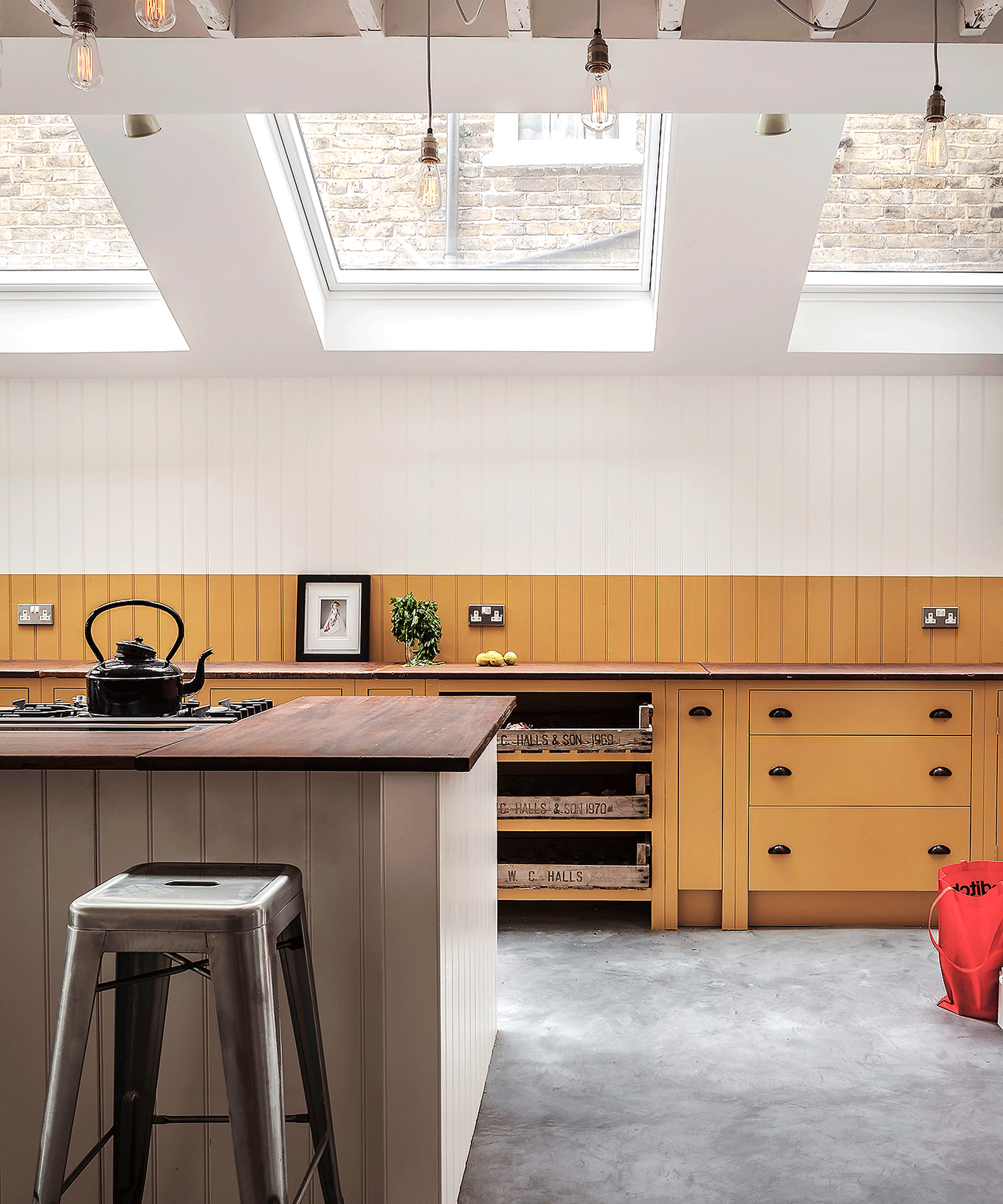 Two-tone kitchen with yellow cabinets and white walls