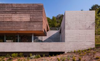 The house is made of concrete, wood and glass