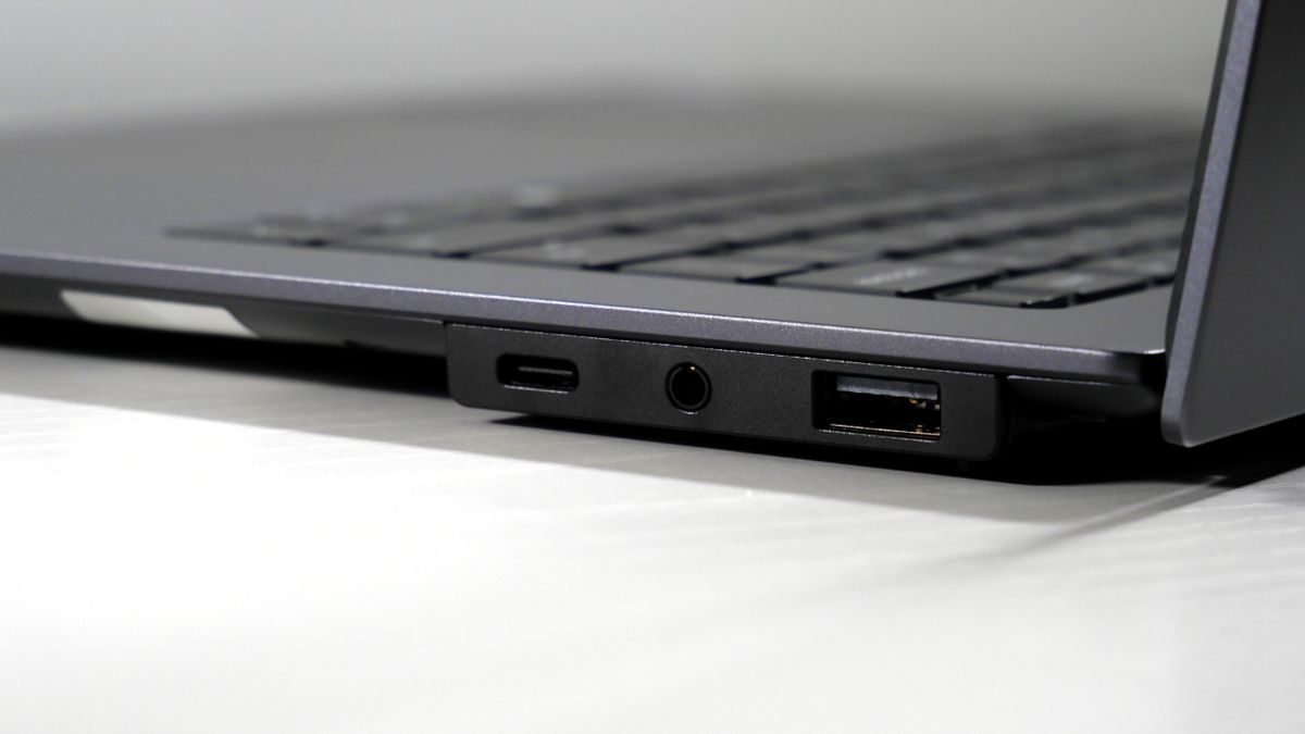 Lenovo ThinkPad X9-15 Gen 1 Aura Edition open on a white desk, highlighting the ports on the right.