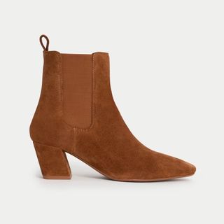 Cutouts of tan suede pointed boots with heels from M&S on a white background