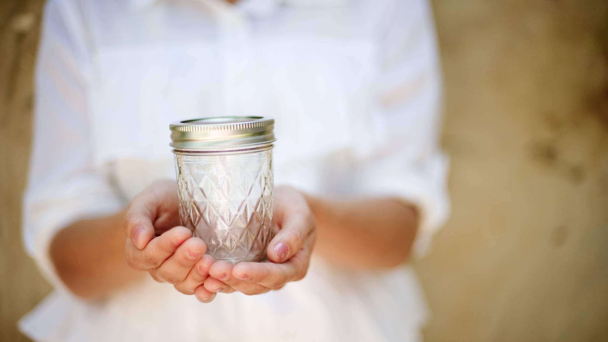 Woman holding mason jar