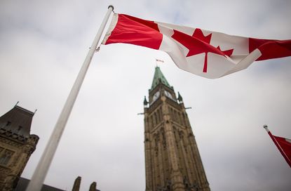 Canadian flag in front of Parliament Hill