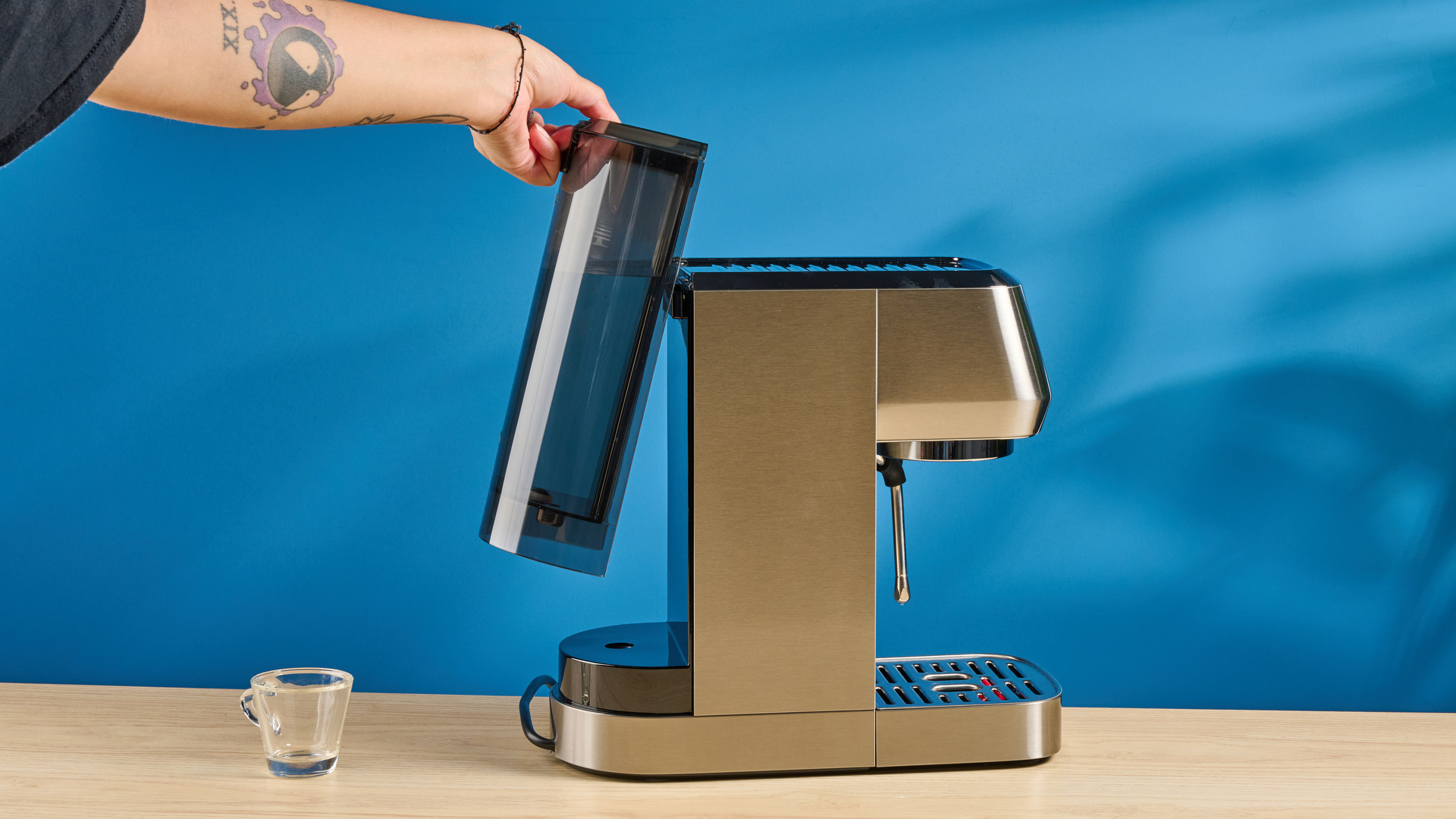 the casabrews 3700 essential espresso machine in silver with a compact footprint and shiny reflective metal casing