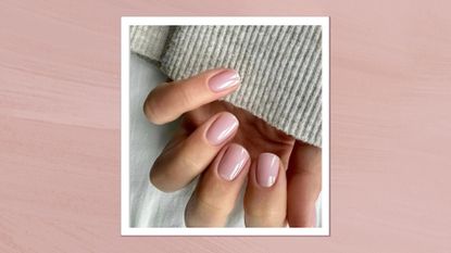 A close-up of a hand with sheer pink nails created by nail artist Megan Rose (@gel.bymegan), against a white linen backdrop with the sleeve of a grey jumper visible and in pink template