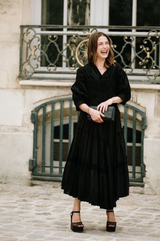 woman wearing a black midi work dress