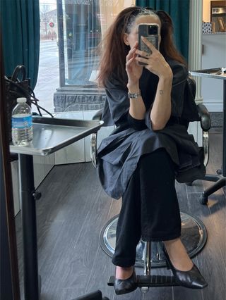 Eliza Huber in the salon chair with brown hair dye in her formerly blonde hair.