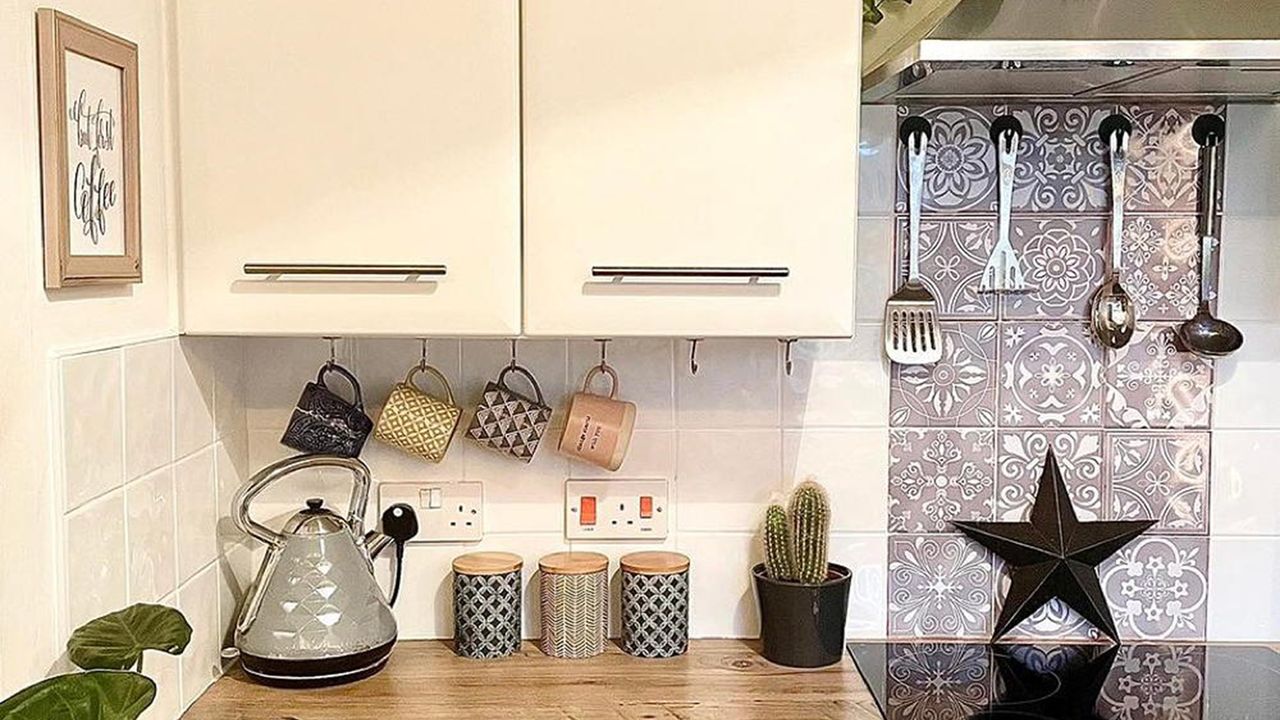 white kitchen with cabinets and hanging mugs