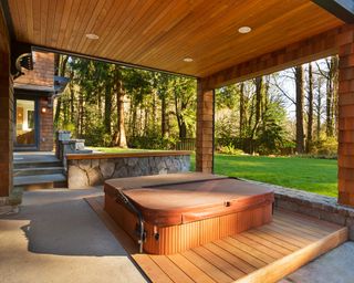 hot tub with decking and cover