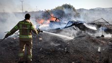 Israeli firefighter puts out blaze started by Hezbollah rockets