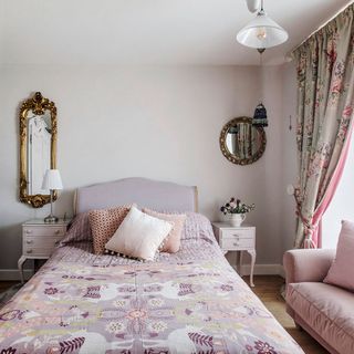 bedroom with pink coloured and mirrors on wall
