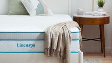 Linenspa hybrid mattress pictured on a wooden bed frame is the best cheap Amazon mattress under $400